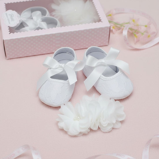 Carriage Boutique ivory lace baby girl baptism shoes with satin bows and matching flower headband with pearls.
