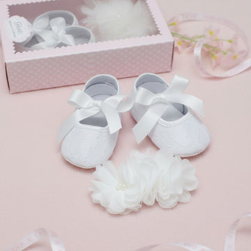 Carriage Boutique ivory lace baby girl baptism shoes with satin bows and matching flower headband with pearls.