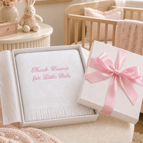 Carriage Boutique Julius Berger white baby blanket with pink embroidery in a gift box with a pink ribbon