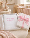 Carriage Boutique Julius Berger white baby blanket with pink embroidery in a gift box with a pink ribbon