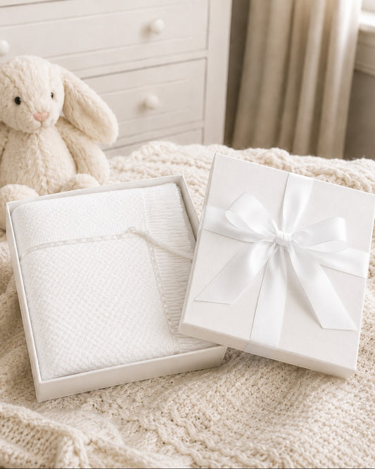 Carriage Boutique Julius Berger white baby blanket with lace trim in a gift box with a satin ribbon bow