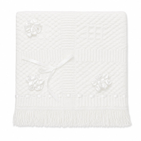 Carriage Boutique Julius Berger white christening blanket with textured knit pattern, satin ribbon bows, and fringe.
