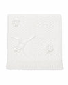 Carriage Boutique Julius Berger white christening blanket with textured knit pattern, satin ribbon bows, and fringe.