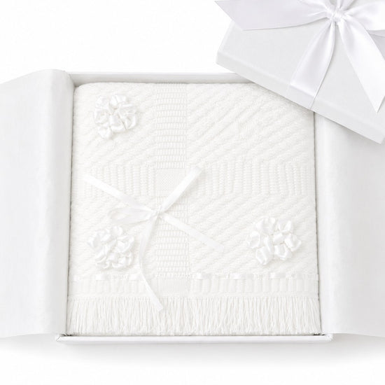 Carriage Boutique Julius Berger white christening blanket with floral accents and fringe in a gift box.