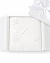 Carriage Boutique Julius Berger white christening blanket with floral accents and fringe in a gift box.