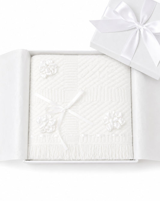 Carriage Boutique Julius Berger white christening blanket with floral accents and fringe in a gift box.