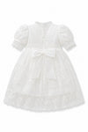 Carriage Boutique white lace christening gown with puffed sleeves, satin bow, and intricate embroidery back view.