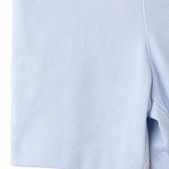 Close-up of the light blue cotton fabric texture on a Carriage Boutique Smocked Sailboats Bobby Suit.