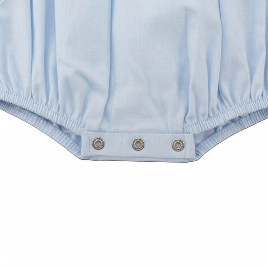 Carriage Boutique light blue smocked carousel horse bubble romper with Peter Pan collar and snap closure.