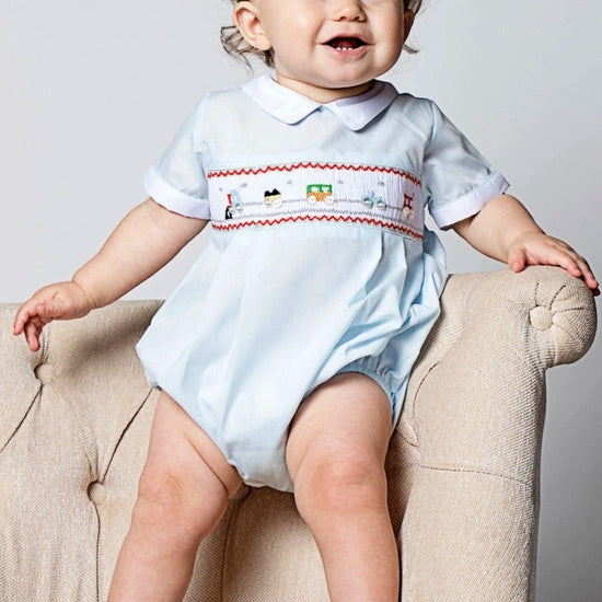 Carriage Boutique light blue bubble romper with smocking and train motif, Peter Pan collar, white piping, short sleeves.