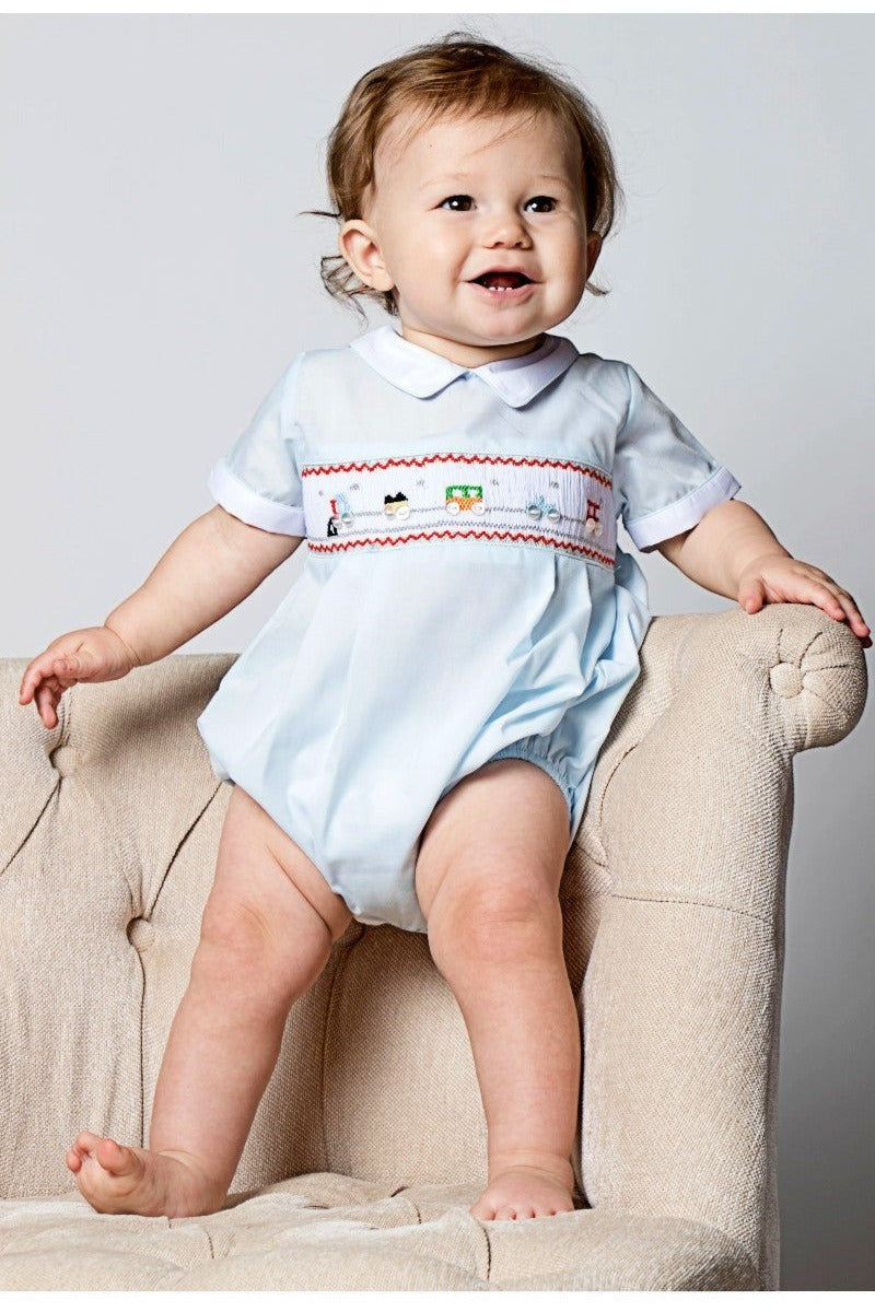 Carriage Boutique light blue bubble romper with smocking and train motif, Peter Pan collar, white piping, short sleeves.