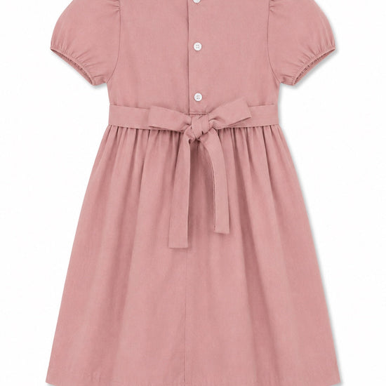 Back view of Carriage Boutique mauve suede-like baby dress with short puff sleeves, button closure, and waist tie.