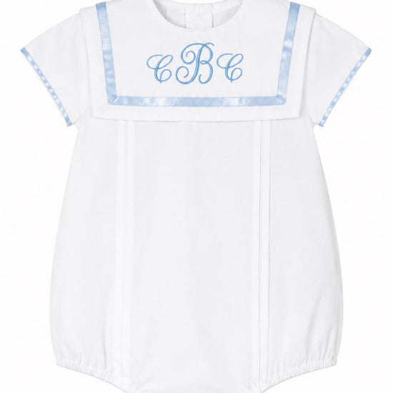 Carriage Boutique white baby boy bubble romper with blue monogram, Peter Pan collar, and elasticized leg openings.