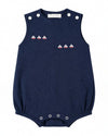 Carriage Boutique navy blue sleeveless bubble romper with embroidered sailboats and white button accents.