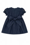 Carriage Boutique navy blue baby girl dress with a back bow, puffy sleeves, and zip closure, back view.