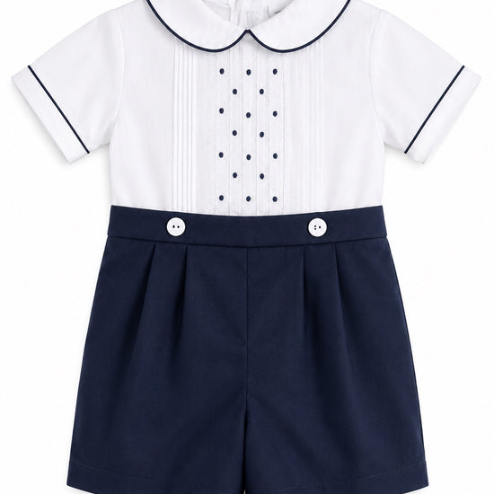 Carriage Boutique navy and white bobbie suit with pintucks, embroidered dots, and a Peter Pan collar for baby boys.