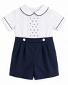 Carriage Boutique navy and white bobbie suit with pintucks, embroidered dots, and a Peter Pan collar for baby boys.