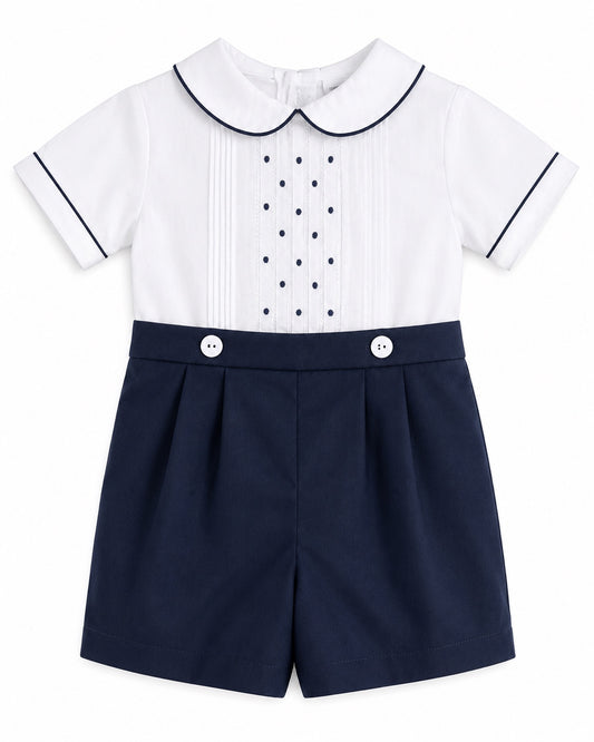 Carriage Boutique navy and white bobbie suit with pintucks, embroidered dots, and a Peter Pan collar for baby boys.