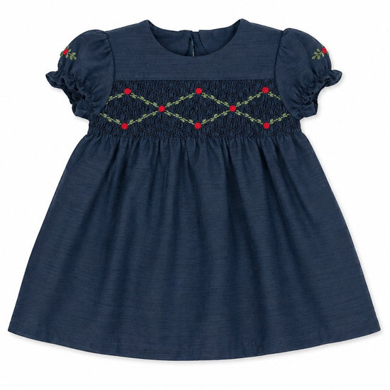 Carriage Boutique navy blue baby girl dress with smocked floral embroidery, puffy sleeves, and round neck.