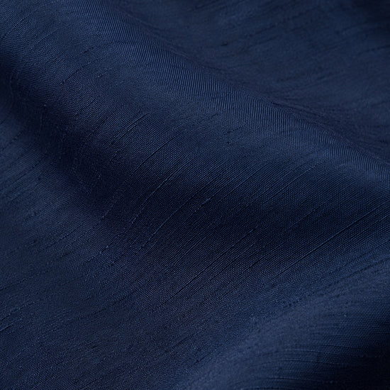 Close-up of navy blue poly silk fabric from a Carriage Boutique baby boy suspender shorts set with textured weave.