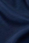 Close-up of navy blue poly silk fabric from a Carriage Boutique baby boy suspender shorts set with textured weave.