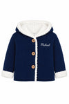 Carriage Boutique navy knit cotton baby jacket with white sherpa lining, hood, and wooden button front closure.