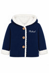 Carriage Boutique navy knit cotton baby jacket with white sherpa lining, hood, and wooden buttons.