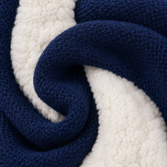 Close-up of Carriage Boutique navy knit cotton fabric with soft off-white sherpa lining texture