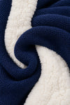 Close-up of Carriage Boutique navy knit cotton fabric with soft off-white sherpa lining texture
