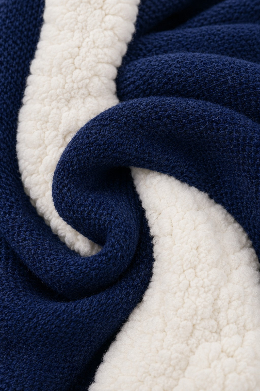Close-up of Carriage Boutique navy knit cotton fabric with soft off-white sherpa lining texture