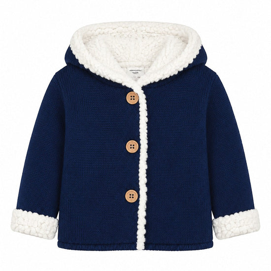 Carriage Boutique navy knit cotton baby jacket with a white sherpa-lined hood, cuffs, and three front wooden buttons.