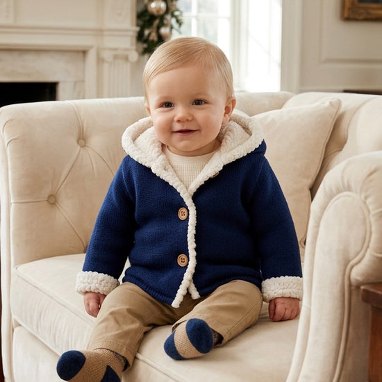 Carriage Boutique navy knit cotton baby jacket with cozy white sherpa lining, hood, and front button closure.