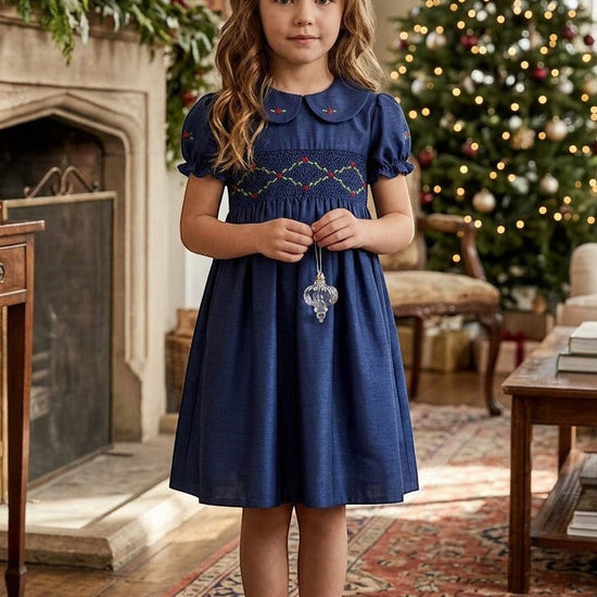 Carriage Boutique navy blue silk toddler party dress with smocked floral collar and puffy sleeves in holiday setting