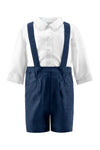 Carriage Boutique navy poly silk suspender shorts paired with a white long-sleeved collared shirt for baby boys.