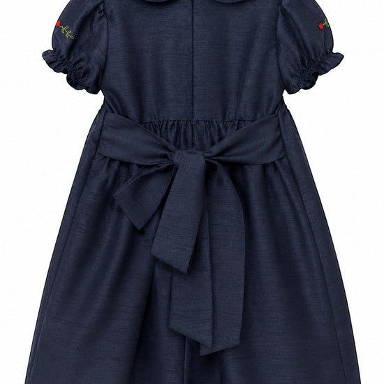 Carriage Boutique navy poly silk toddler party dress with back bow, puffy sleeves, and floral embroidery detail.