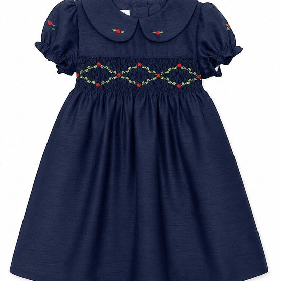 Carriage Boutique navy toddler dress with smocked floral embroidery, puffy sleeves, and a round collar.