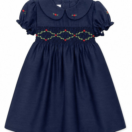 Carriage Boutique navy blue toddler party dress with smocked floral embroidery, puffy sleeves, and a round collar.