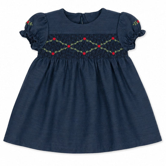 Carriage Boutique navy blue baby girl dress with smocked floral embroidery, puffy sleeves, and a round neck.