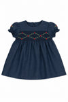 Carriage Boutique navy blue baby girl dress with smocked floral embroidery, puffy sleeves, and a round neck.