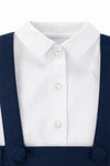 Carriage Boutique navy poly silk suspender shorts paired with a crisp white long-sleeve button-down shirt