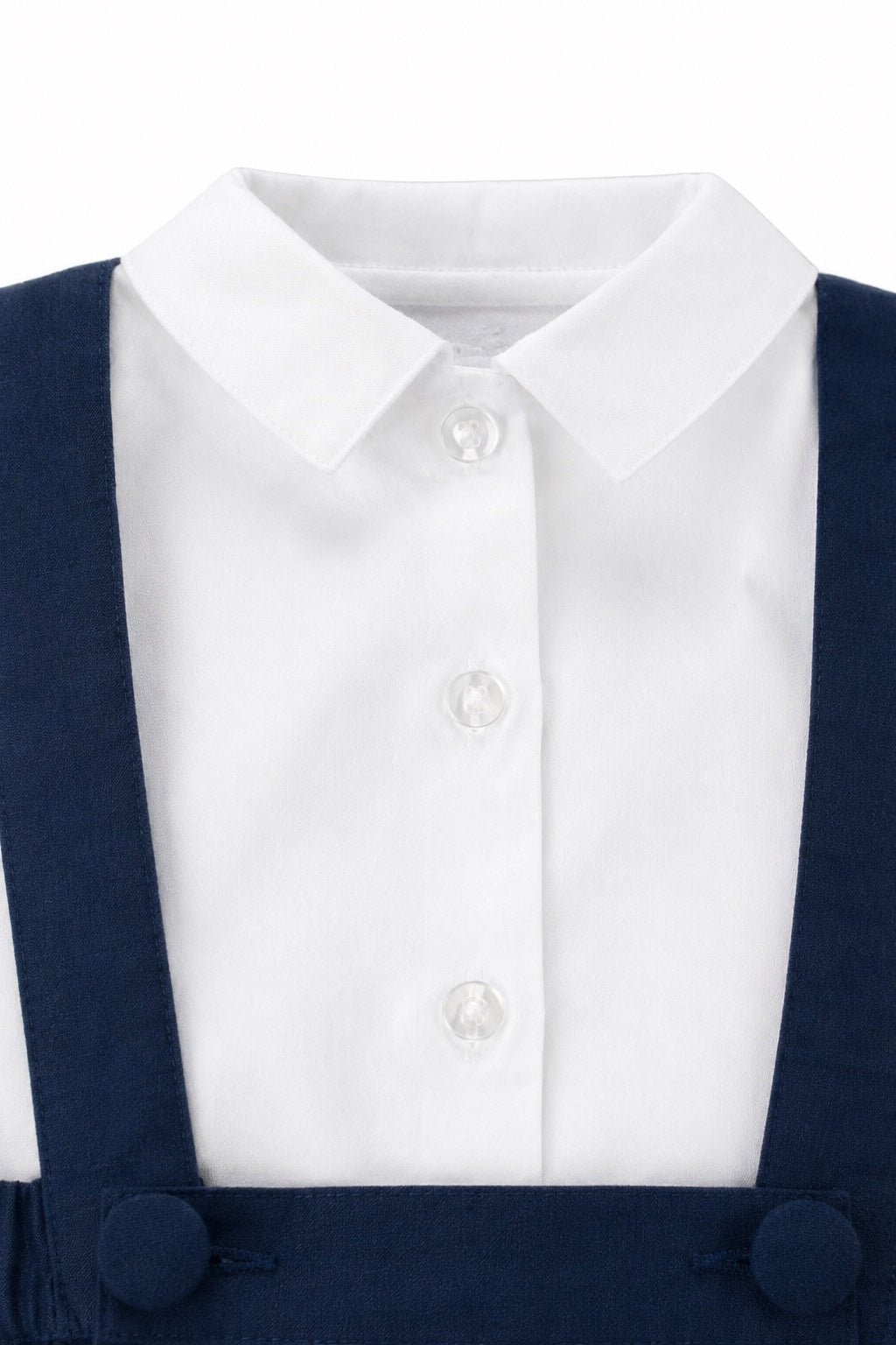Carriage Boutique navy poly silk suspender shorts paired with a crisp white long-sleeve button-down shirt