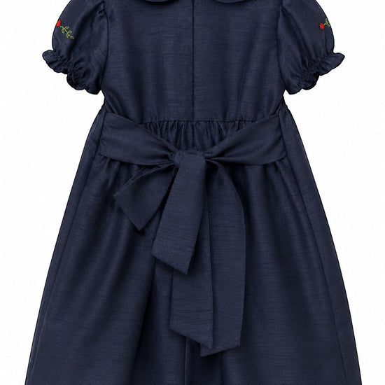 Carriage Boutique navy blue poly silk toddler party dress with a back bow, round collar, and floral sleeve detail.