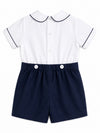 Carriage Boutique navy and white bobbie suit with Peter Pan collar, navy piping, and decorative buttons on shorts.