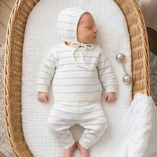 Carriage Boutique newborn 3-piece set in white with sky-blue stripes, featuring a long-sleeve top, leggings, and hat.