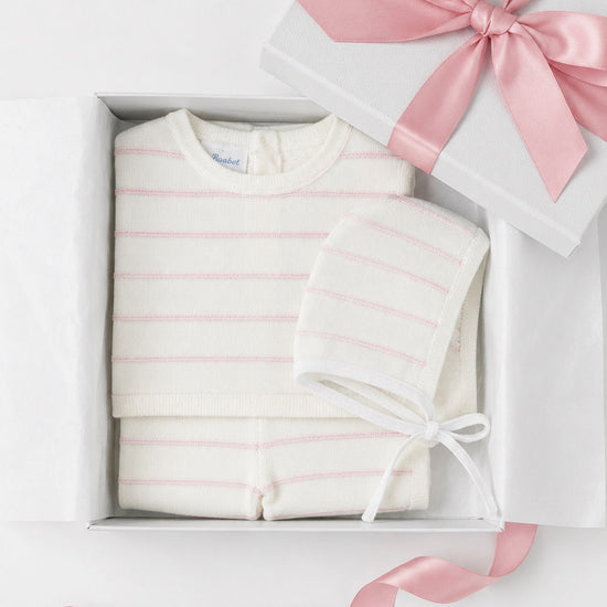 Carriage Boutique newborn 3-piece set in cream knit with blush pink stripes, including top, leggings, and bonnet.