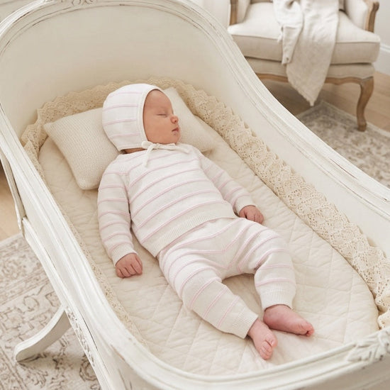 Carriage Boutique newborn 3-piece set with white and blush pink striped knit top, leggings, and matching baby bonnet.