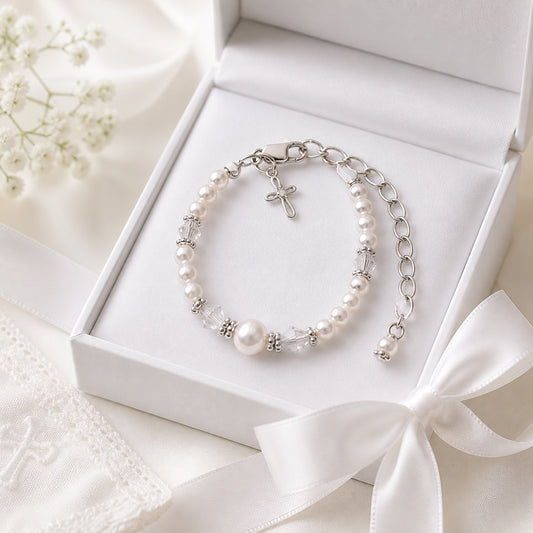 Carriage Boutique sterling silver baby cross bracelet with freshwater pearls and crystals in a white keepsake box.