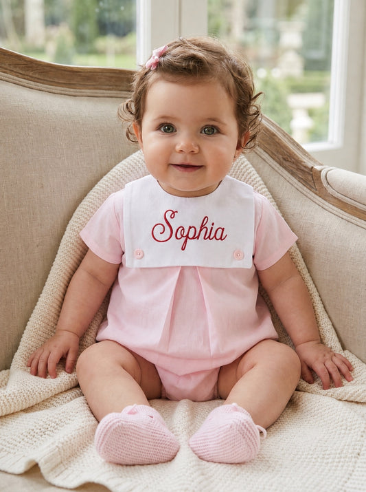 Carriage Boutique baby girl bubble romper in light pink cotton with a white personalized button bib and matching booties