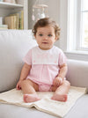 Carriage Boutique baby girl bubble romper with white button bib and pink cotton shorts featuring custom embroidery