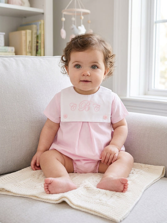 Carriage Boutique baby girl bubble romper with white button bib and pink cotton shorts featuring custom embroidery